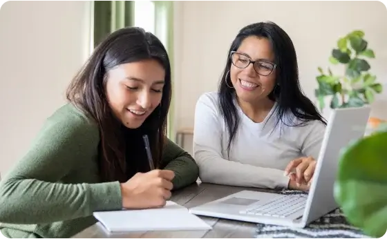 Mother and daughter doing homework together at home