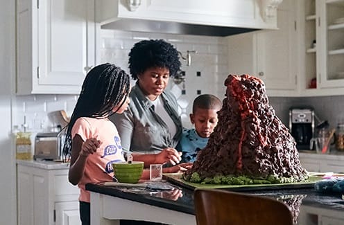 mom and children making a model of a volcano